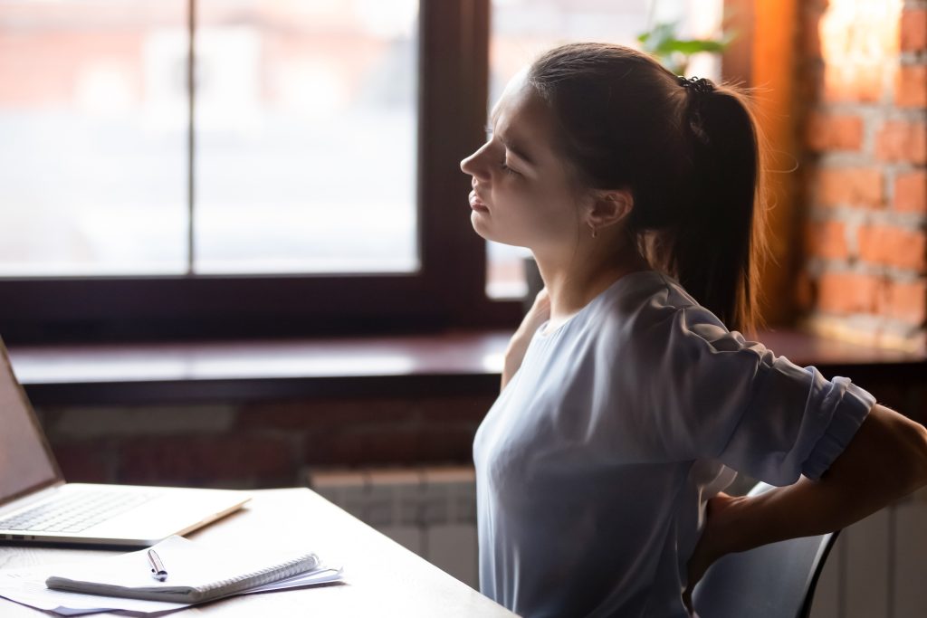 Office worker sitting with poor posture at desk