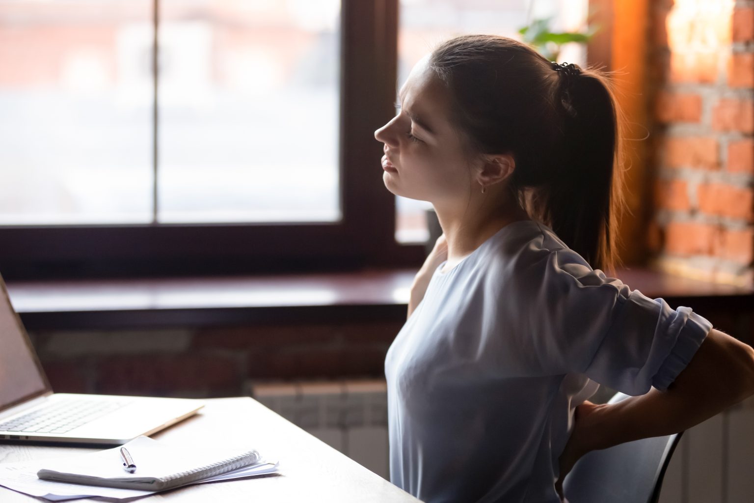 Office worker sitting with poor posture at desk